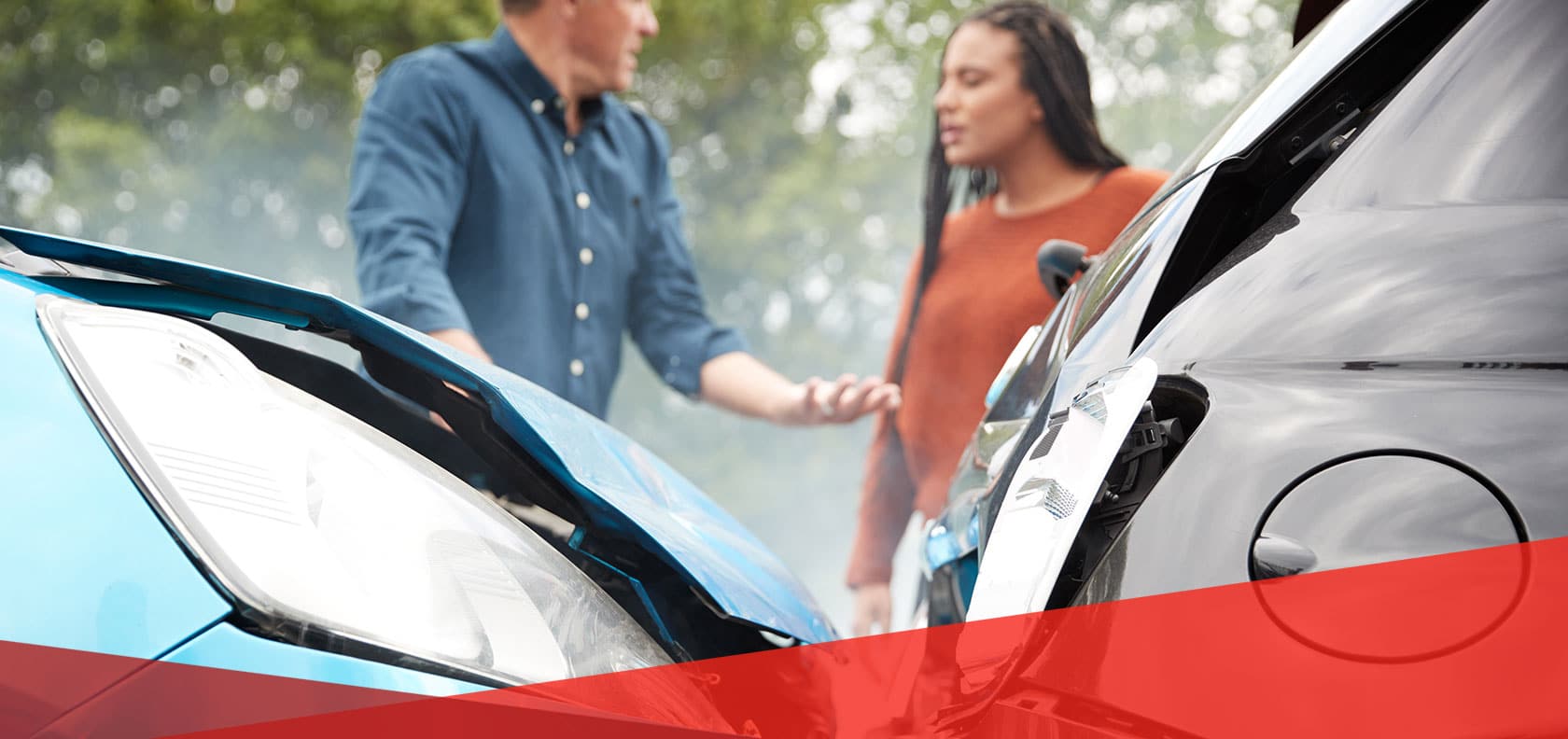 Two drivers look at damaged cars after their car crash