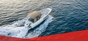 Boat_Insurance_Blog-Feature Couple with a pet in a rented apartment with furniture and moving boxes.