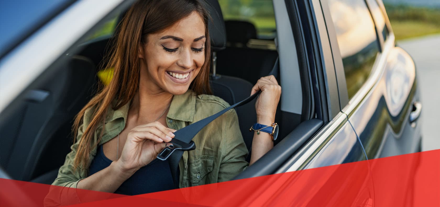 Woman puts on seat belt in car