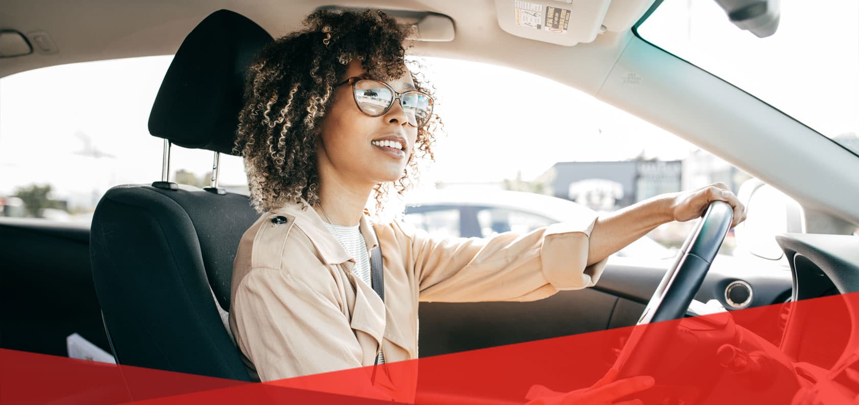 woman-drives-behind-steering-wheel-of-car